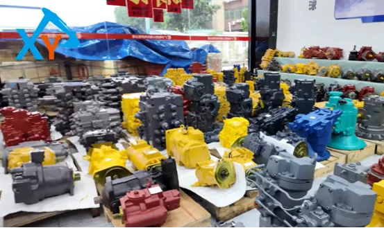 Excavator hydraulic pumps and control valves displayed in warehouse